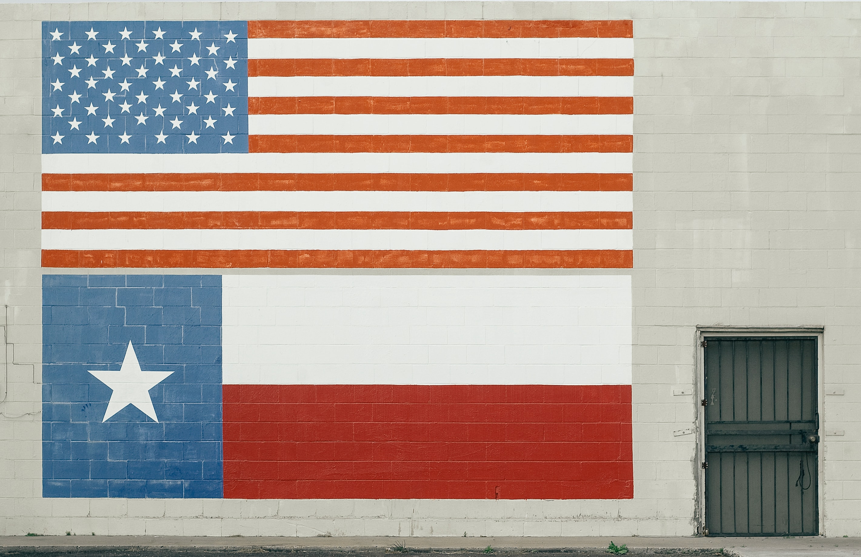 Flags of the US and Texas on a wall